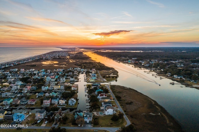 aerial view at dusk with a water view