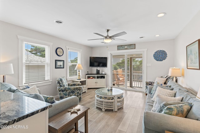 living room featuring ceiling fan and light hardwood / wood-style flooring