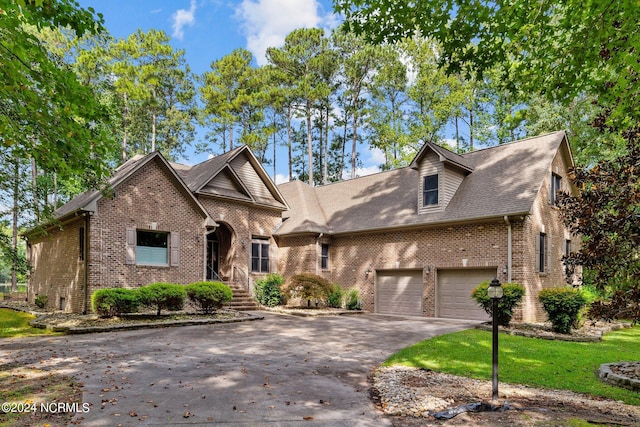 view of front of house featuring a front yard and a garage