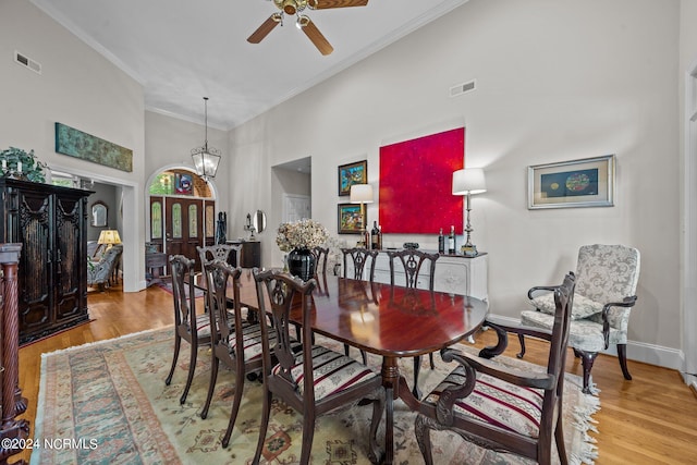 dining space featuring ornamental molding, ceiling fan, and light hardwood / wood-style floors