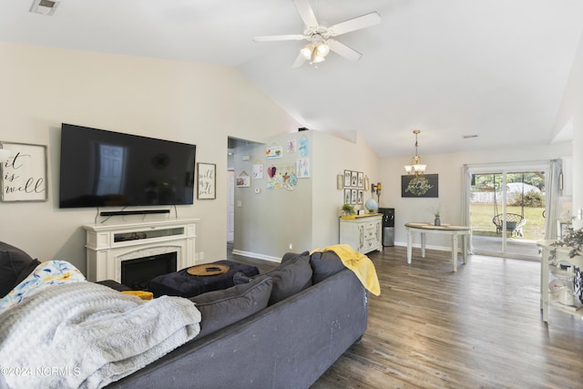 living area with lofted ceiling, ceiling fan with notable chandelier, wood finished floors, a high end fireplace, and baseboards