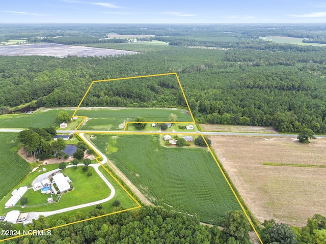 drone / aerial view featuring a rural view and a view of trees
