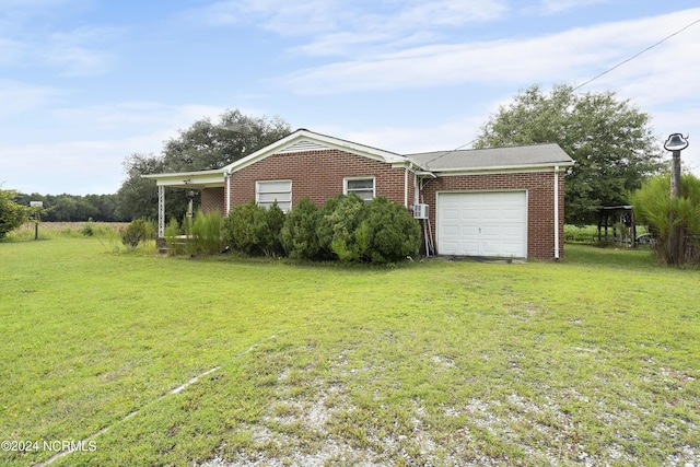 view of side of home with an attached garage, a yard, driveway, and brick siding