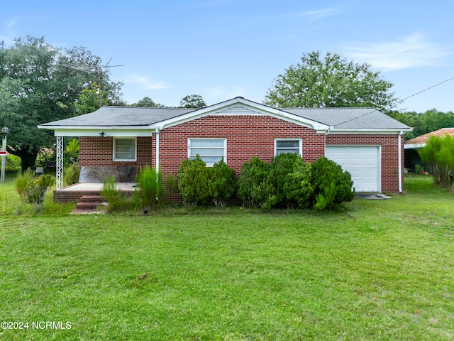 view of front of house with a garage and a front yard