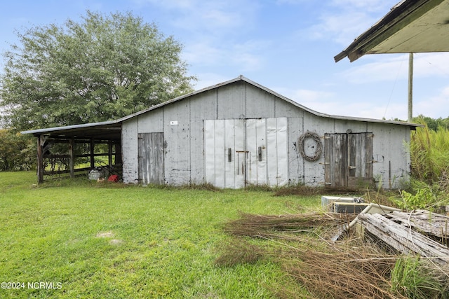 view of pole building with a yard