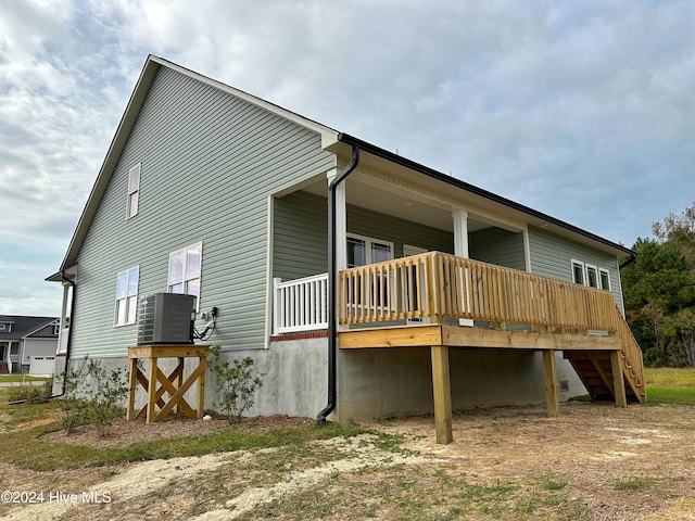 rear view of property with central AC