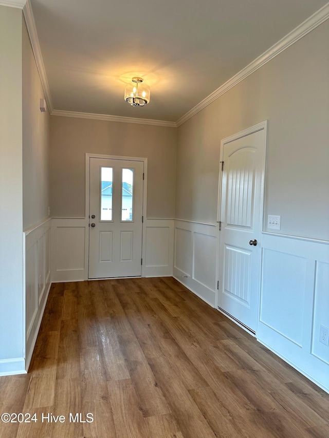 foyer with hardwood / wood-style floors and ornamental molding