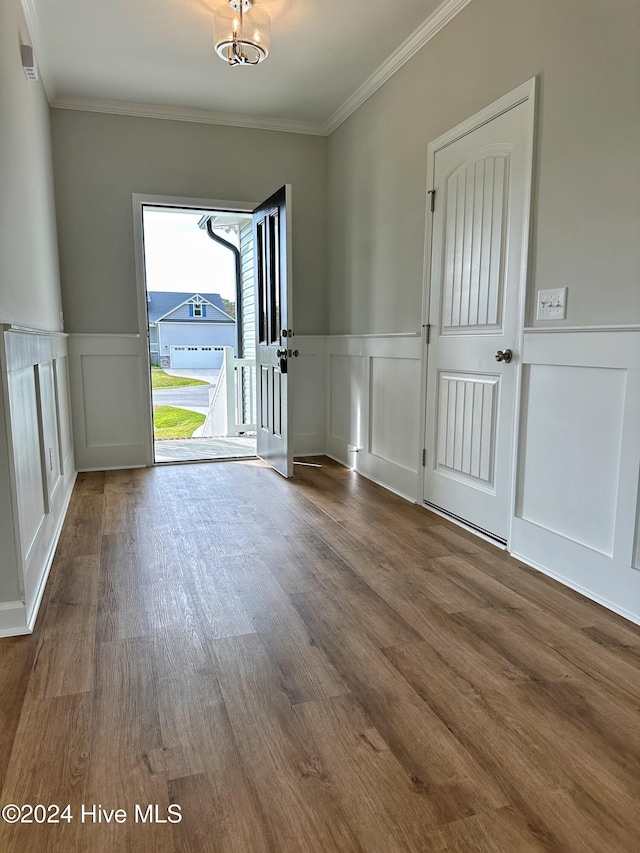 entryway featuring crown molding, a chandelier, and hardwood / wood-style flooring