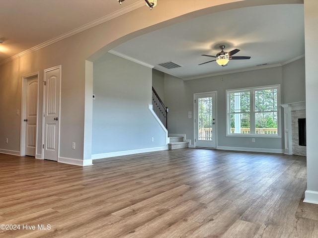 unfurnished living room featuring light wood-type flooring, ceiling fan, and crown molding