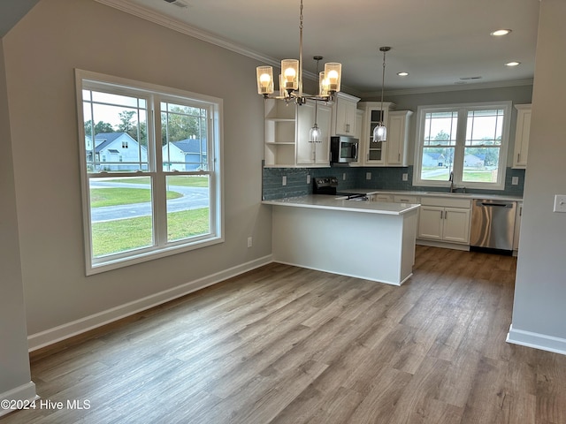 kitchen featuring plenty of natural light, kitchen peninsula, and stainless steel appliances