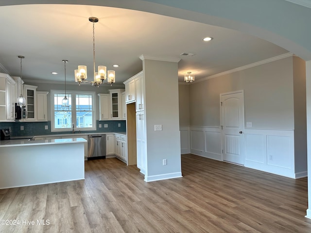 kitchen featuring white cabinets, pendant lighting, light hardwood / wood-style floors, and stainless steel dishwasher