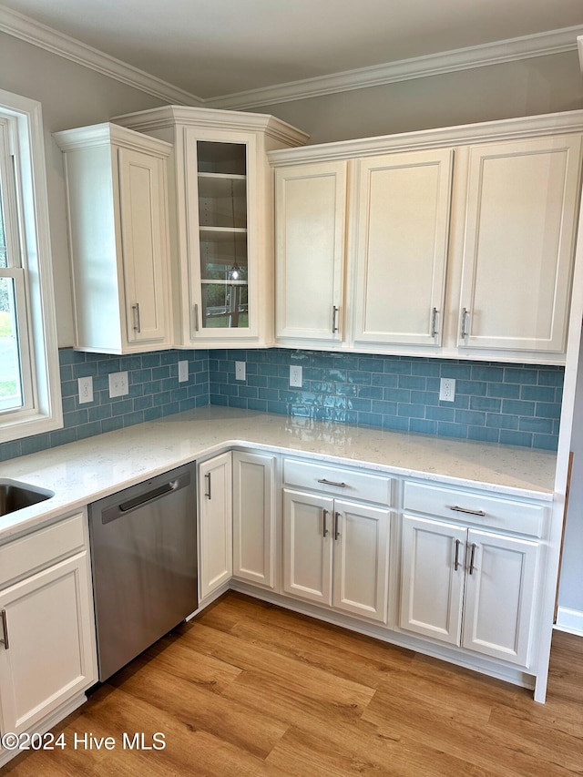 kitchen with white cabinets, dishwasher, light wood-type flooring, and ornamental molding