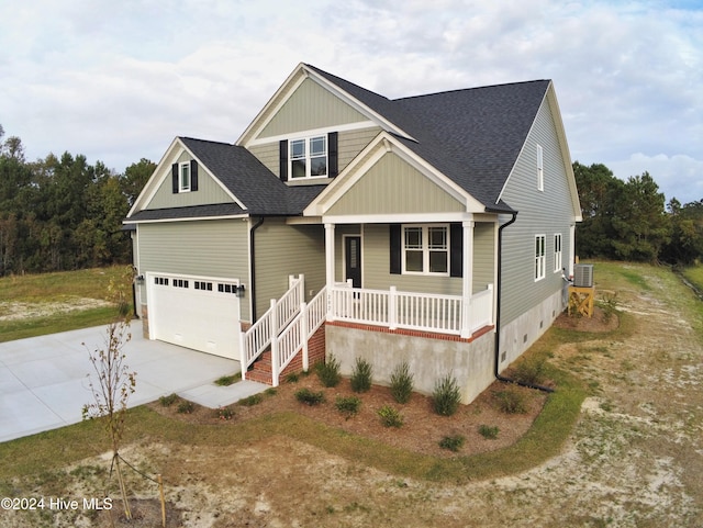 view of front of property featuring cooling unit, covered porch, and a front yard