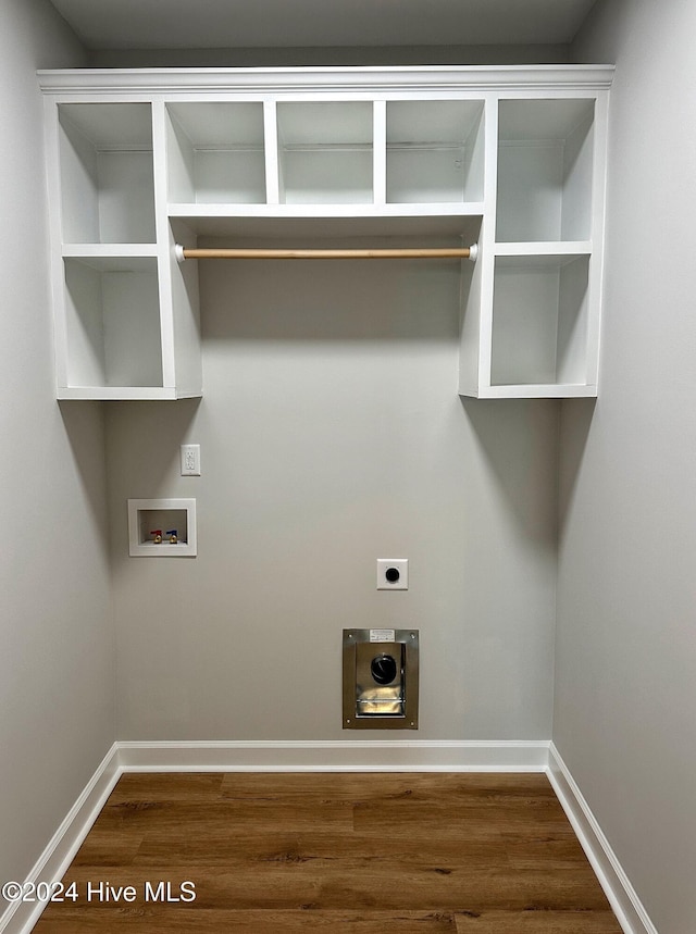 clothes washing area featuring electric dryer hookup, dark hardwood / wood-style flooring, and hookup for a washing machine