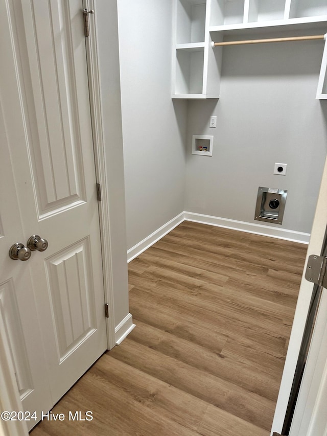 clothes washing area featuring hardwood / wood-style floors, hookup for a washing machine, and electric dryer hookup