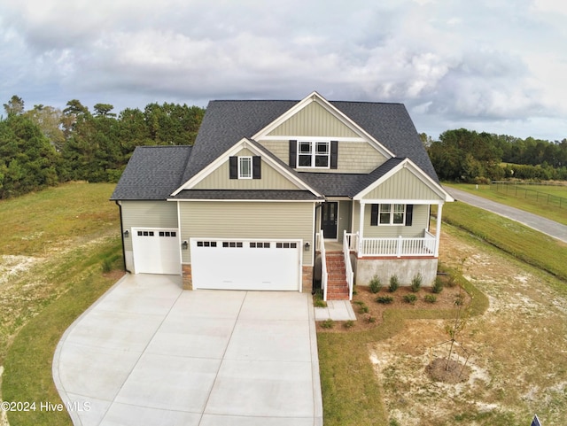 craftsman-style home with a front yard, a porch, and a garage