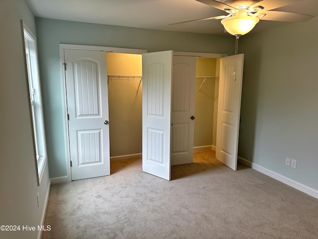 unfurnished bedroom featuring ceiling fan and light colored carpet