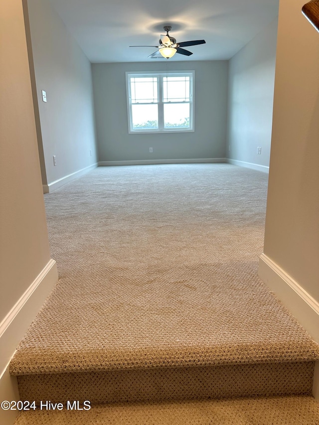 unfurnished room with ceiling fan and carpet floors