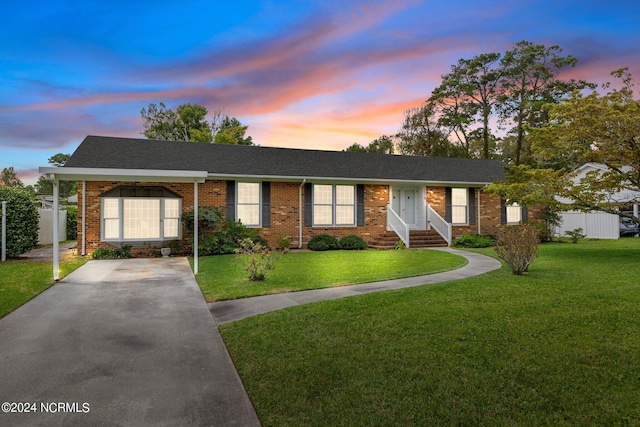 ranch-style home featuring a lawn