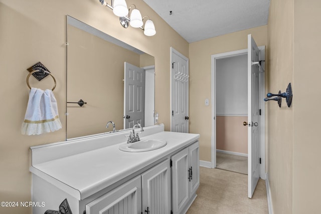 bathroom with a textured ceiling and vanity