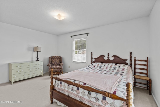 carpeted bedroom featuring a textured ceiling