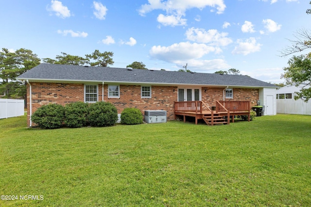 back of property featuring a yard and a deck