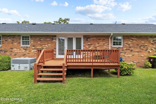 back of property with central AC, a lawn, and a wooden deck