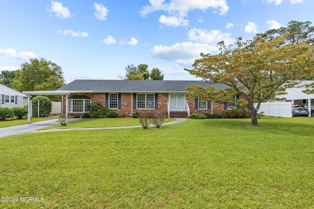 ranch-style house with a front yard and a carport