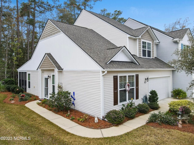 view of front of home with a front lawn and a garage