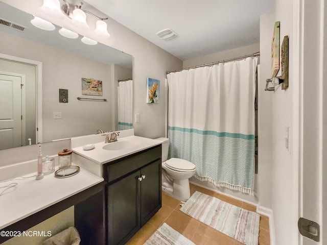 bathroom with tile patterned flooring, vanity, and toilet