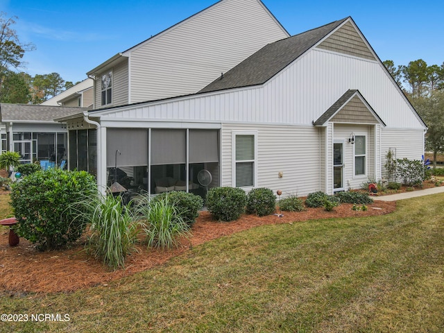 exterior space with a sunroom and a front yard