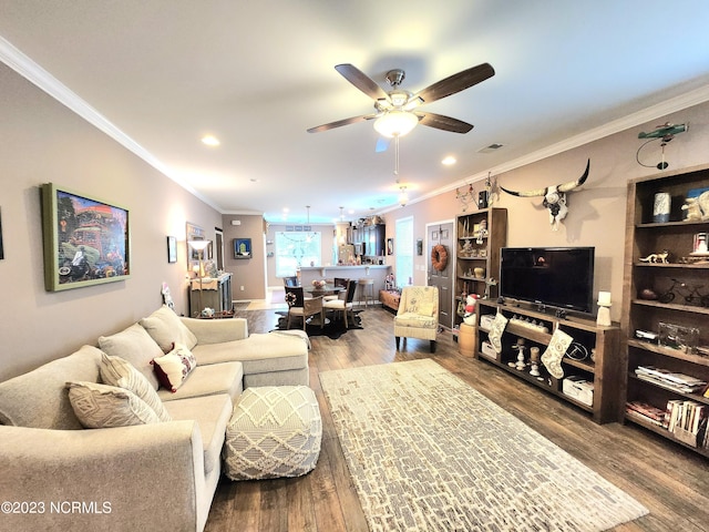 living room featuring ceiling fan, hardwood / wood-style flooring, and crown molding