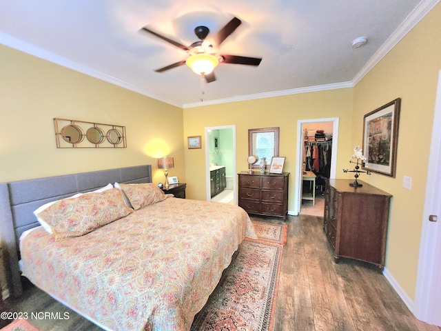 bedroom featuring a walk in closet, a closet, dark wood-type flooring, connected bathroom, and ceiling fan