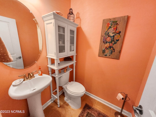 bathroom with toilet and tile patterned floors