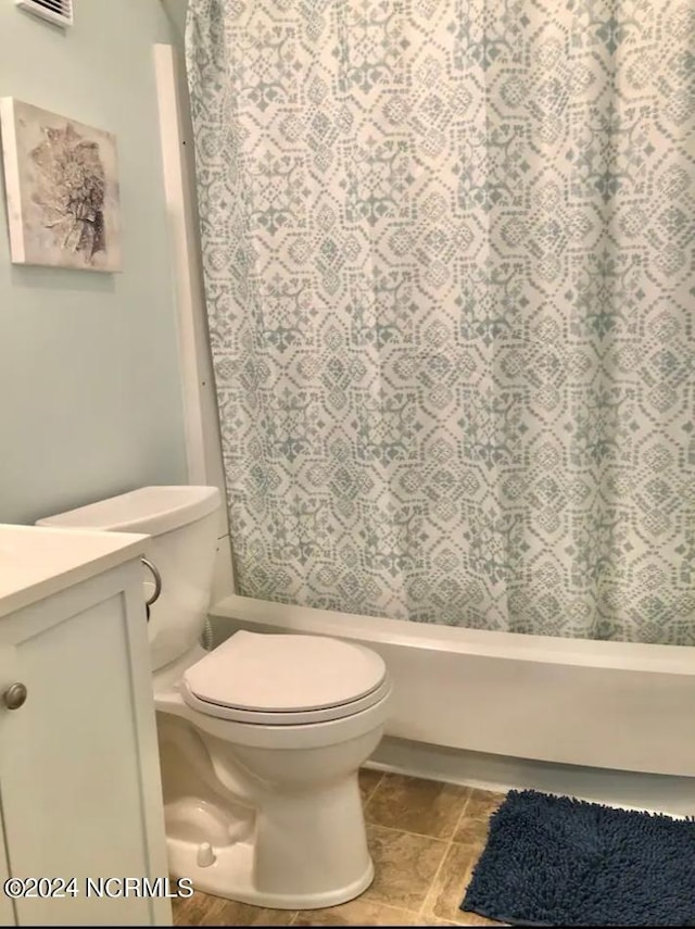 full bathroom with shower / bath combo, toilet, and vanity