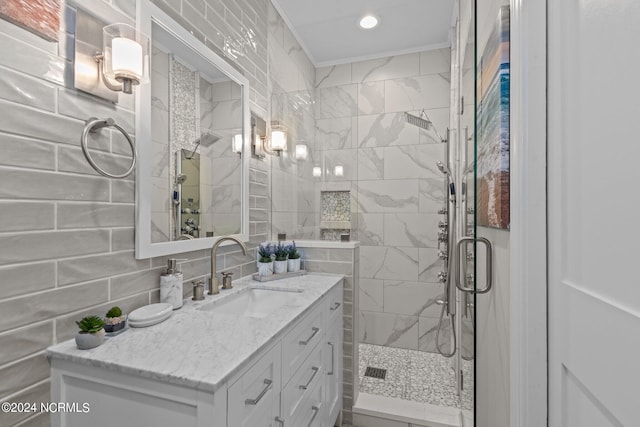 bathroom with vanity, backsplash, tile walls, and walk in shower