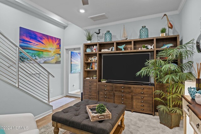 living room featuring crown molding, ceiling fan, and hardwood / wood-style floors