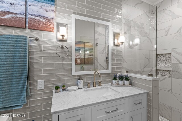 bathroom with vanity and tile walls