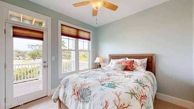 bedroom featuring a ceiling fan, baseboards, access to exterior, and carpet floors