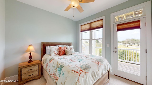 carpeted bedroom with ceiling fan and access to exterior