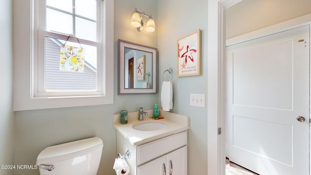 bathroom featuring toilet and vanity