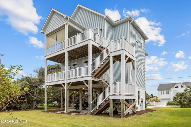 back of property with a lawn and a deck