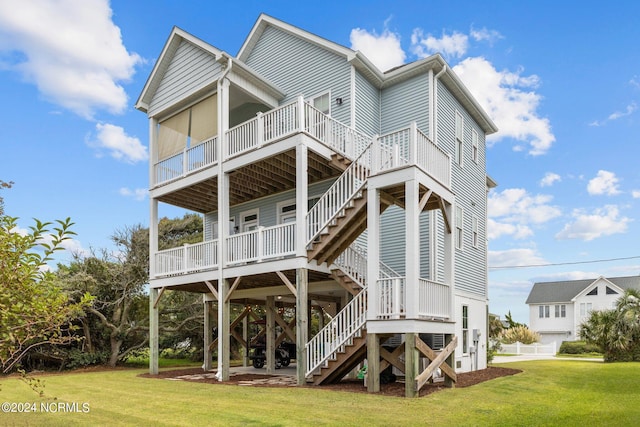 back of house featuring a wooden deck, a yard, and stairway