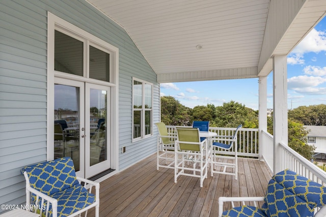deck featuring outdoor dining space and french doors