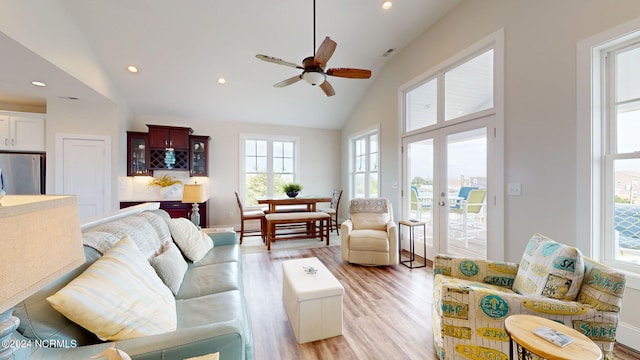 living room featuring french doors, high vaulted ceiling, ceiling fan, and light hardwood / wood-style floors