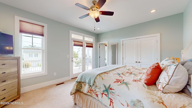 carpeted bedroom featuring access to exterior, ceiling fan, and a closet