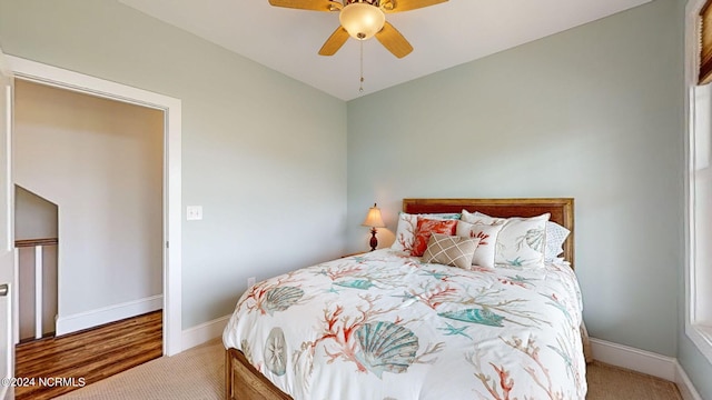 carpeted bedroom with baseboards and ceiling fan