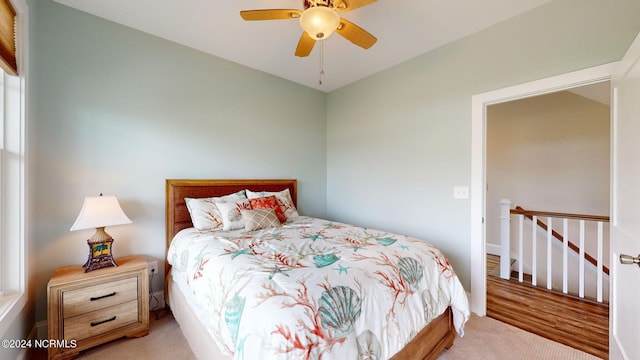 bedroom with ceiling fan and light carpet