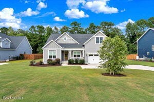 view of front of property featuring a garage and a front lawn