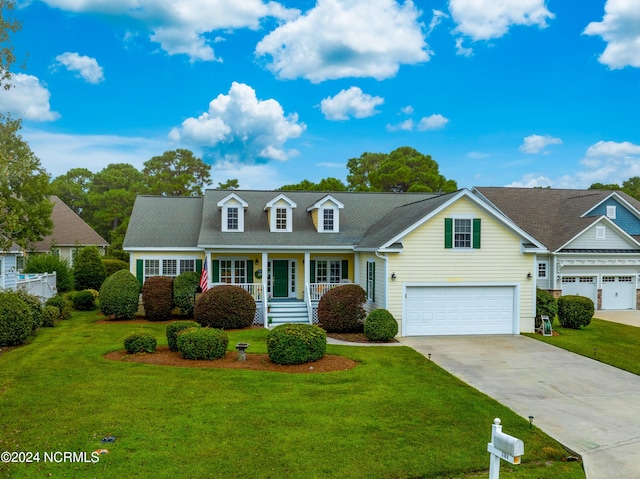 3184 Wild Azalea Way SE, Southport, NC 28461 - view of front of property with covered porch, concrete driveway, and a front lawn